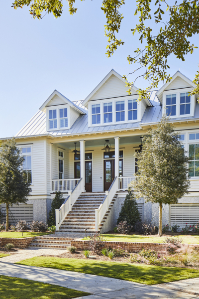 Lowcountry custom home with white siding and metal roof in Charleston, SC.